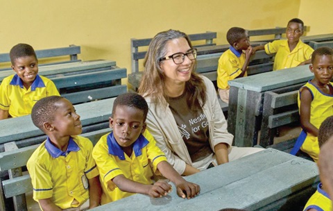 The classroom block at Akroma. Inset: Salomé Azevedo, Managing Director of Nestle Ghana Ltd, with pupils of Adarkwa Methodist School in their new classroom