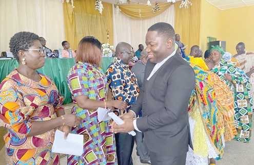 Maxwell Ofori Kpodo, Asamankese Circuit Court Judge, congratulating the new board members