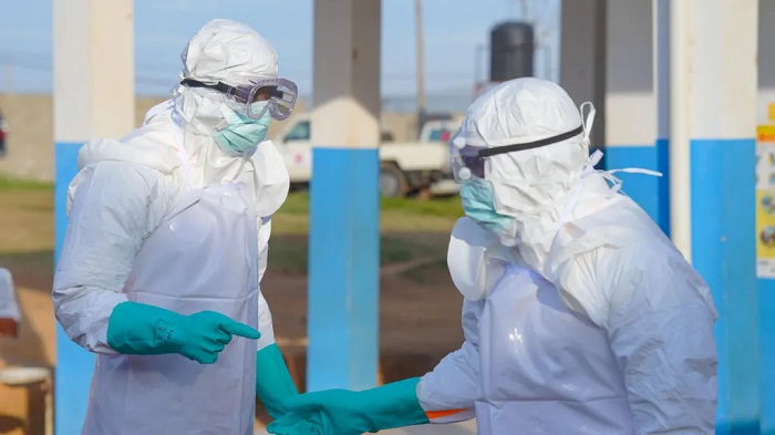 Medical staff must wear protective equipment when treating people with Ebola because it spread through bodily fluids