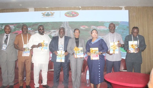 Linda Ocloo (3rd from right), Greater Accra Regional Minister, and other dignitaries at the Korle-Klottey Municipal Business and Investment Forum, holding copies of the Korle-Klottey Investment Guide after its launch at the forum