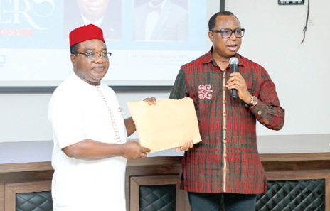 Dr Joseph Whittal (right), Chair, Network of National Human Rights Institutions i­n West Africa, presenting the documents to Dr Anthony Ojukwu, Executive Officer, Nigeria Network Of National Human Rights Institutions, during the handing over ceremony in Accra. Picture: ELVIS NII NOI DOWUONA 