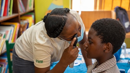 A student of the Nima Cluster of school being screened