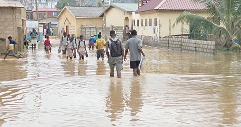 Some students walking through the floods Some students walking through the floods