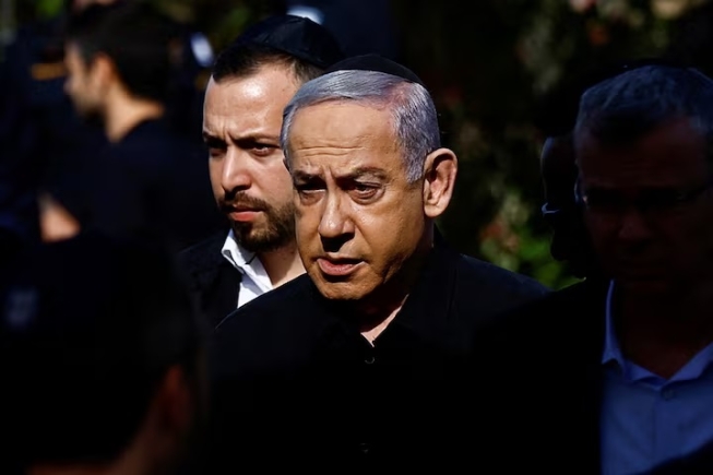 Israeli Prime Minister Benjamin Netanyahu attends the funeral of Gal Meir Eisenkot, 25, an Israeli solider and the son of Israeli cabinet minister and former military chief Gadi Eisenkot, who was killed in northern Gaza during the ongoing ground operation by Israel's military in the Gaza Strip, in Herzliya, Israel, December 8, 2023. REUTERS/Clodagh Kilcoyne