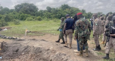 Brigadier General Maxwell Obuba Mantey, the Director-General of NACOC, setting the seized  drugs ablaze (inset)