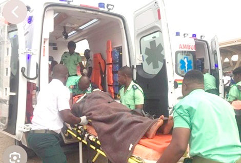 Staff of the National Ambulance Service transferring a sick person into an ambulance