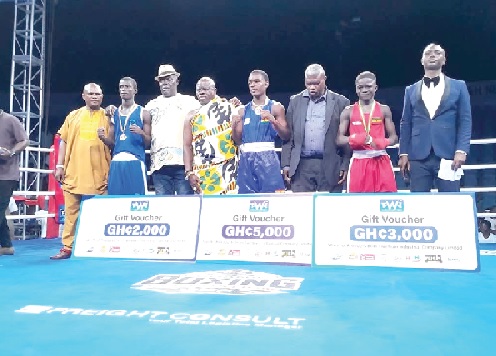 Mathias Ashitey (arrowed) and other winning boxers displaying their cheques with GBF officials and dignitaries
