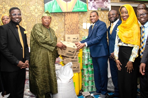 Farihan Alhassan (3rd from right), Managing Director, GCB Bank PLC, presenting some items to a representative of the National Chief Imam