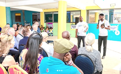 A teacher briefing the board during the visit. with him is Rev. Vincent Ntiamoah Yeboah (left), Director of the school
