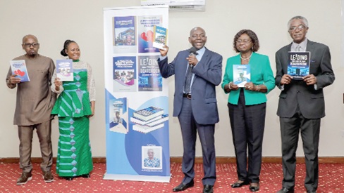 Benjamin Amenumey (3rd from right), President, Chartered Institute of Bankers, being assisted by Prof. Robert Hinson (left),  Professor of Marketing, University of Ghana Business School; Justice Awuku-Sao (right), Author of the books, and some dignitaries to launch the books. Picture: ELVIS NII NOI DOWUONA 