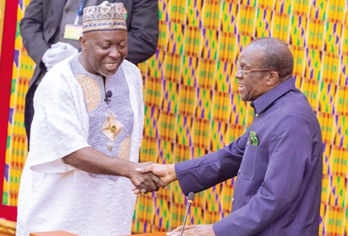 Alban Sumana Kingsford Bagbin (right), Speaker of Parliament, congratulating Alhaji Baba Jamal M. Ahmed, MP for Ayawaso East, after swearing him in