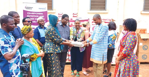 François Nduwimana (middle), Head of Cooperation at Global Affairs Canada, being supported by other officials to present the  items to Dr Chrysantus Kubio (4th from left), Northern Regional Health Director. Looking on is Esenam Kavi De Souza (1st from right), Country Director of Children Believe