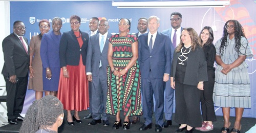Kwamena Asomaning (5th from left), CEO, Stanbic Bank Ghana; Kyler Kelhofer  (4th from right), Country Manager, IFC; Folasade Femi Lawal (6th from left), Country Manager, Mastercard, and some officials of IFC, Mastercard and Stanbic Bank. Picture: ERNEST KODZI