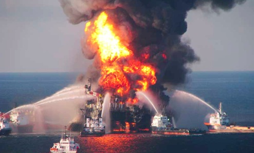 An oil tanker engulfed in flames after a missal strike