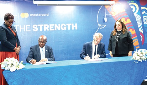 Kwamina Asomaning, Chief Executive of Stanbic Bank Ghana, and Kyle Kelhofer, IFC Senior Country Manager for Ghana and Nigeria, signing the agreement.