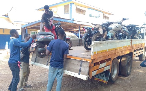 Some of the seized motorbikes being loaded onto a truck