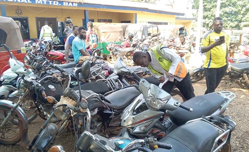   An officer inspecting some of the seized motorbikes