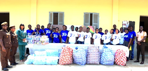  Yaa Asor-Kyei (3rd from left), Assistant Headmistress in charge of Domestic Affairs, Wesley Grammar School, with prison officers and some students of the school after the presentation ceremony.
