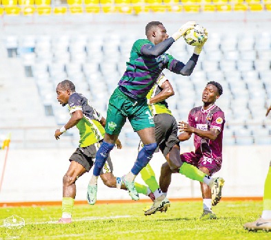 Gideon Aseako of Dreams FC pulling off a timely save to thwart Yaw Danso, Heart of Lions’ attacker, in their encounter in Cape Coast yesterday