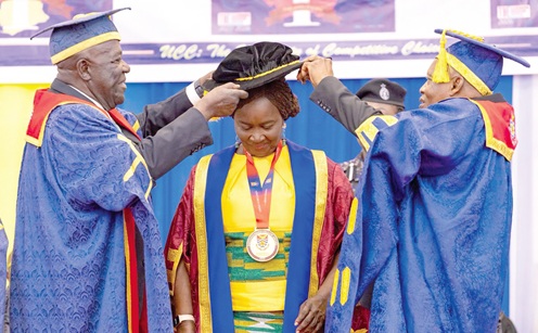 Sir Sam Jonah (left), Chancellor of UCC, and Justice William Atuguba, Chairman of the UCC Governing Council, robing Prof. Naana Jane Opoku-Agyemang at the ceremony