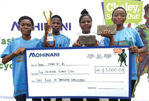 Patience Crowey (2nd from right), Teacher, Teshie LEKMA 12 JHS, and student representatives displaying the trophy, dummy cheque and bricks after the challenge