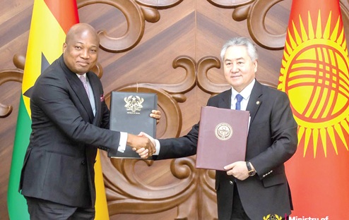 Samuel Okudzeto Ablakwa (left), Minister of Foreign Affairs, exchanging copies of signed agreements with Jeenbek Kulubayev, Foreign Minister of Kyrgyzstan
