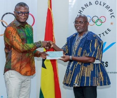 Richard Akpokavie (right), GOC President presenting the cheque to Kofi Iddi Adams, Sports Minister