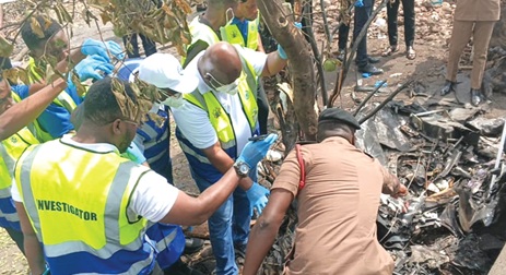 Investigators at the crash scene gathering information