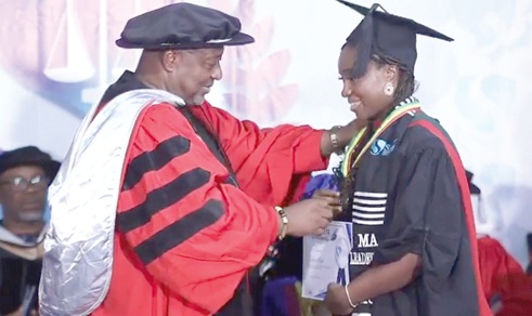 One of the graduates being decorated with her medal and certificate. Picture SAMUEL OHENE EWUR