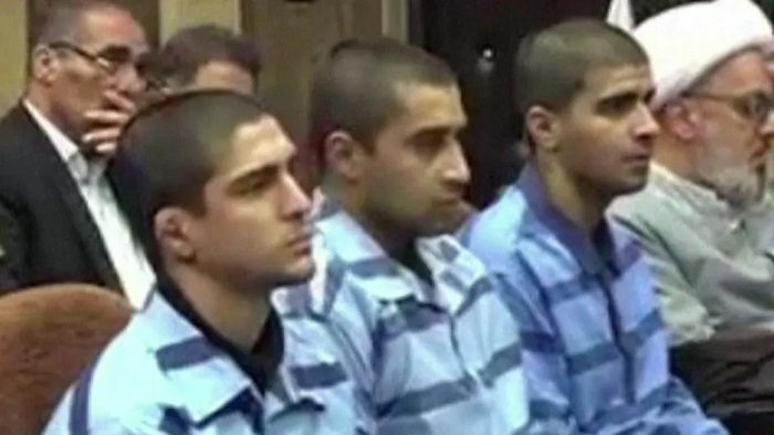 Iran's state media released footage on Thursday of the three men at their trial