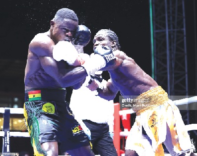 Freezy Macbones (left) and Jonathan 'Worldwide' Tetteh slugging it out during their December 20 encounter for the WBA Africa Light Heavyweight title 