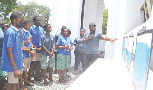 Richard Appiah Otoo (right), Chief Regional Manager, Ghana  Water Limited, Accra East, explaining the water treatment process to students at the event. Picture: EDNA SALVO KOTEY