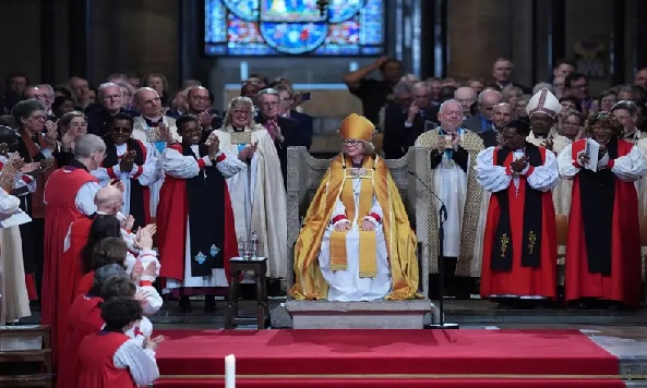 Members of the clergy and the congregation applaud after Dame Sarah Mullally was installed as Archbishop of Canterbury