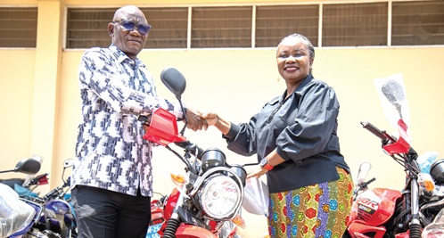 Agatha Quayson  (right), Country Leader of The Hunger Project–Ghana, presenting   the motorcycles to Dr Damien Punguyire, Eastern Regional Director of Health Services