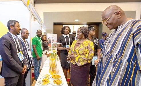 Prof. Naana Jane Opoku-Agyemang (2nd from right), Vice-President, interacting with some exhibitors. With her is Sylvester Adinam Mensah (right), Chief Executive of GEXIM