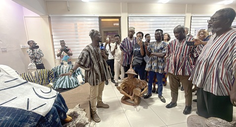 Patrons at the exhibition being briefed by Samuel Acquaah (left) of the Ghana Museums and Monuments Board. Picture: CALEB VANDERPUYE