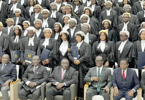 Justice Paul Baffoe-Bonnie (seated 2nd from left), Chief Justice, flanked by Dr Dominic Ayine (left), Attoney-General and Minister of Justice, and Justice Gabriel Pwamang, and other members of the General Legal Council with the newly qualified lawyers after the enrolment