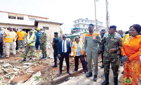 Lt Col. Frank Osei Amponsah (2nd from right), the Commanding Officer of the 48 Engineers Regiment, briefing Prof. Naana Jane Opoku-Agyemang (right), Vice-President, during her visit to the Accra Newtown Experimental Basic School disaster site yesterday