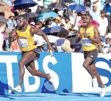 • Benjamin Azamati powers on after receiving the baton from Edwin Gadayi (right)