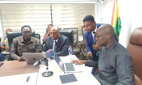 Dr Cassiel Ato Forson (right), Minister of Finance, being aided to file his tax returns. With him are Martin Kolbil Yamborigya (left), Commissioner, Domestic Tax Division, Ghana Revenue Authority, and Thomas Nyarko Ampem (2nd from left), Deputy Minister of Finance