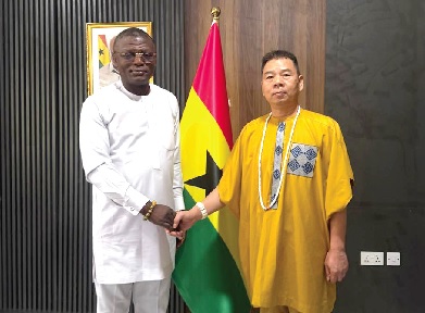 Liu Wen Min and Kofi Adam (left), Minister of Sports and Recreation