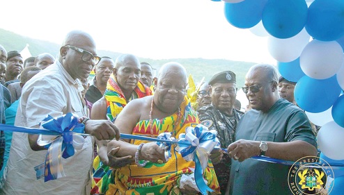President Mahama (right) being assisted by Nene Sakite II (middle), Okletey Terlarbi (left), Deputy Minister for the Interior, and Christian Tetteh Yohuno, the IGP, to inaugurate the facility (inset)