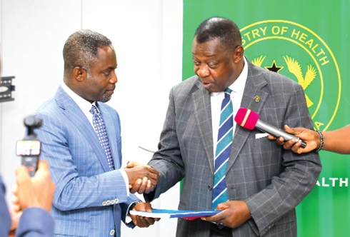 Prof. Agyeman Badu Akosa (right), a former Director- General, Ghana Health Service, and Chairman, Investigation Committee, presenting the report to Kwabena Mintah Akandoh, Minister of Health. Picture: ELVIS NII NOI DOWUONA 