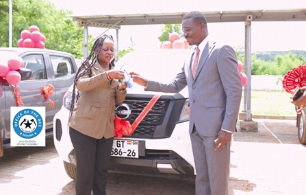 Ignatius Godfred Dordoe, District Chief Executive for Shai-Osudoku, handing over a key of one of the vehicles to a worker at the transport unit of the assembly