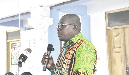 Dr Harrison Belley (right), Chairman of the Volta Regional branch, GJA, addressing the audience