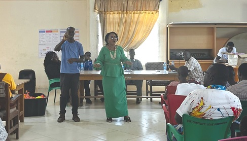 Richlove Amamoo (right), Central Regional Director of Gender, Children and Social Protection, addressing the students