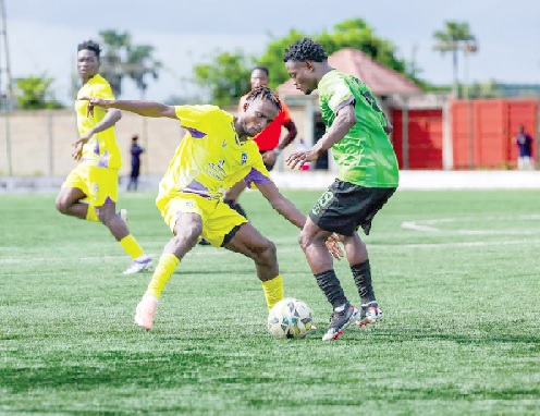 Prince Tweneboah of Basake Holy Stars attempting to dribble past Yaw Osei of Medeama SC (left) during yesterday's game
