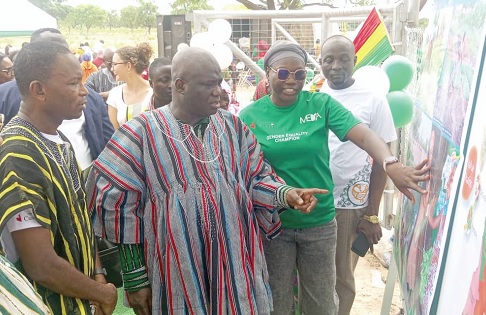 Eric Opoku (middle), Minister of Food and Agriculture, being taken through how the facilities operate by staff of MEDA