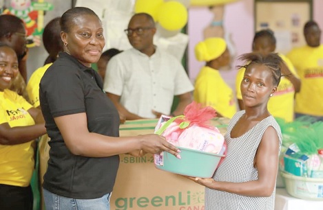 Adjoa Akyema Sampong (left),  CEO, ECL, making a presentation to one of the beneficiaries
