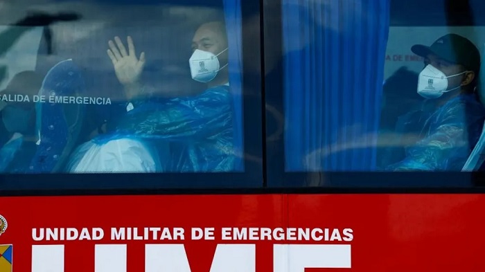 Passengers sit in a bus after disembarking from the cruise ship MV Hondius in the port of Granadilla, Spain's Canary Islands. Photo: 11 May 2026